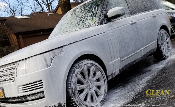 Silver Range Rover in foam bath.