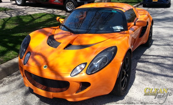 Bright orange Lotus after full detailing.
