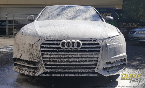 Black Audi A6 in foam bath.