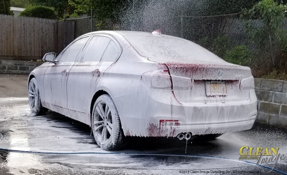 Red BMW 3 Series in foam bath.