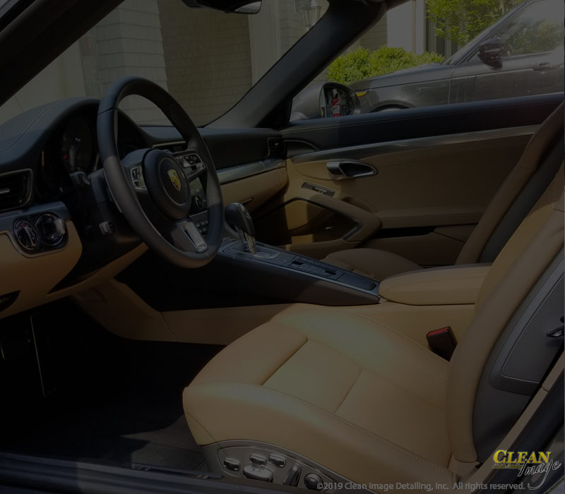 Black Porsche 911 tan interior detailing.
