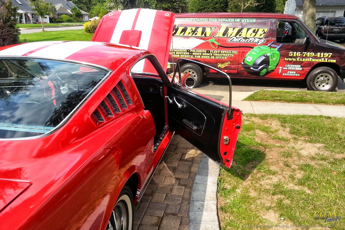 Red mustang with white racing stripes after executive detailing.