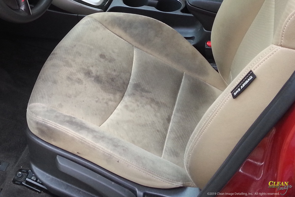 Dirty seat before Odor Removal and Steam Cleaning service.