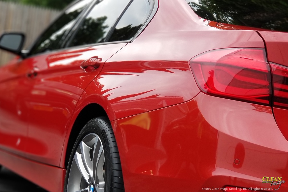 Red BMW 3 Series after paint correction service applied.